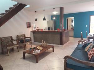 a living room with a couch and a table at Casa Duas Torres in Búzios +15 photos