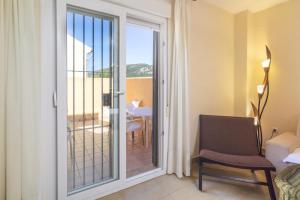 a room with a sliding glass door to a balcony at Zahara Sol Villas y Apartamentos by QHotels in Zahara de los Atunes