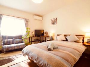 Postel nebo postele na pokoji v ubytování 遥華-Haruka House