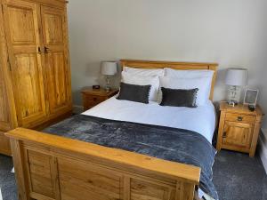 a bedroom with a bed and a dresser at Bridge Farm Hotel in Leeds