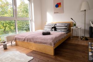 a bedroom with a bed with a teddy bear on it at FULL HOUSE Studios - KornhausDeluxe Apartment - Balkon, WiFi in Dessau