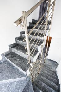 a set of stairs with a metal railing at Luxury Cyprus Villa Turquoise Villa Private Pool Sea View 1 BDR Paphos in Paphos