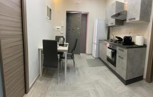 a kitchen with a table and chairs and a stove and refrigerator at Mary’s House in Torre del Greco