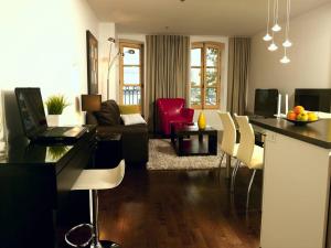 a kitchen and living room with a table and chairs at Les Immeubles Charlevoix - Le 1176 in Quebec City