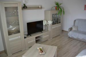 a living room with a large entertainment center with a flat screen tv at Dzintari in Liepāja