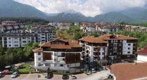 an aerial view of a city with buildings and mountains at Predela 2 Aparthotel in Bansko