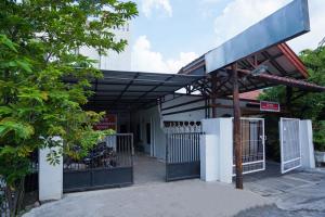 a gas station with a gate and a fence at SPOT ON 2479 Berkah Residence Syariah in Gresik