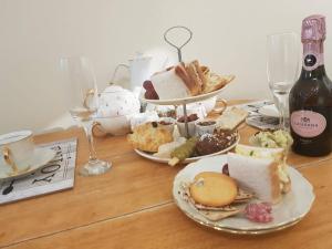 uma mesa coberta com pratos de comida e taças de vinho em The little garden hoose em Inverness
