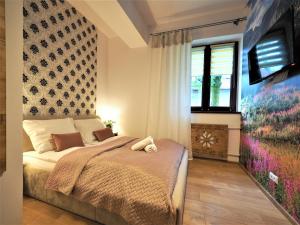 Posteľ alebo postele v izbe v ubytovaní VIP Apartamenty TYTUS