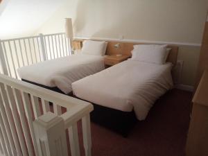 A bed or beds in a room at Moreton Park Hotel 