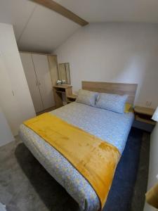 a bedroom with a large bed in a room at Woofles Luxury Caravan at Knaresborough Lido in Knaresborough +16 photos