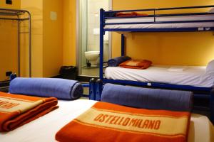 a room with two bunk beds and a bathroom at Hi! Ostello Milano in Milan
