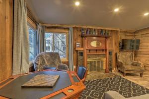 a living room with a table and a tv at Rustic Anchorage Hideaway Walk to Coastal Trail! in Anchorage