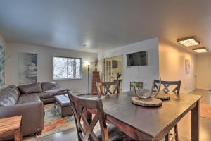 a living room with a table and a couch at Waterfront Apt, Walk to Town and Coastal Trail! in Anchorage