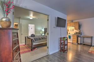 a bedroom with a bed and a television in a room at Waterfront Apt, Walk to Town and Coastal Trail! in Anchorage