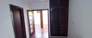 an open door to a room with a hallway at SUÍTES NA PRAIA DO ITAGUÁ conchegouba in Ubatuba