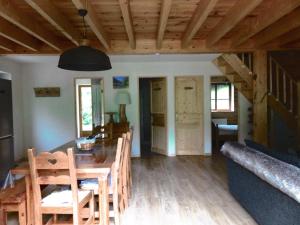 a dining room and living room with a table and chairs at Chalet Le Bordarriben sauna & spa in Gèdre