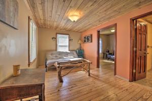 a living room with a couch and a table at Pet-Friendly Cottage with Fire Pit - 3 Mi to SIU! in Carbondale