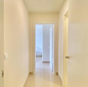 an empty hallway with a door leading to the ocean at Tália XI - Near the beach - Vilamoura in Vilamoura