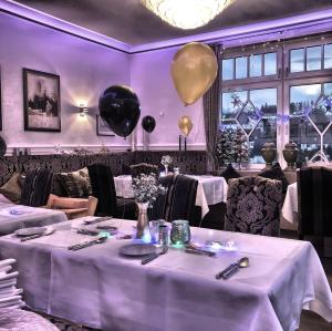 a purple room with tables and balloons on the wall at Hotel Nuhnetal in Winterberg