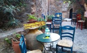 a patio with tables and chairs and a fountain at Byron's Sea View in Monemvasia