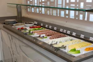 um buffet com muitos tipos diferentes de alimentos em exposição em Best Western Plus Larco Hotel em Lárnaca