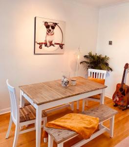 a dining room table with a dog on a skateboard at Beautiful 2 bedroom flat in Camden in London