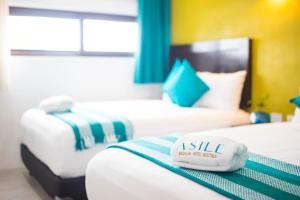 Postel nebo postele na pokoji v ubytování Asilé Hotel Boutique