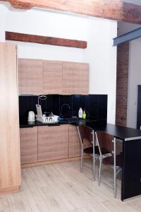 a kitchen with a black counter and chairs at Old Town Mystery- in Poznań +97 photos