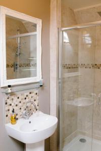 a bathroom with a sink and a shower at Prince of Wales - Townhouse in London