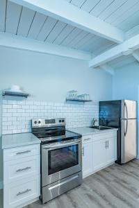 a kitchen with white cabinets and a stove top oven at Boutique Suite #4 in Blue Mountains