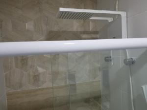 a shower with a glass door in a bathroom at Apartamento Santos Legend in Santos