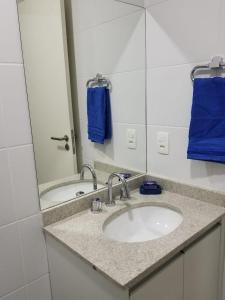 a bathroom with a sink and a mirror at Apartamento Santos Legend in Santos