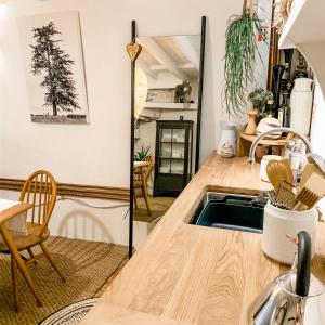 a kitchen with a wooden counter top and a sink at Snowdonia Stone Cottage in Beddgelert