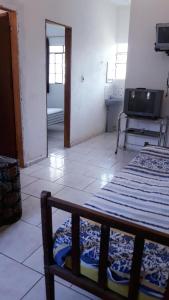 a living room with a bed and a mirror at Casa Rustica Milho Verde in Milho Verde