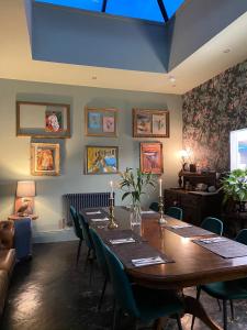 a dining room with a long table and chairs at Lairds House in Bedlington