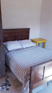 a bedroom with a bed with a wooden headboard at Casa Rustica Milho Verde in Milho Verde
