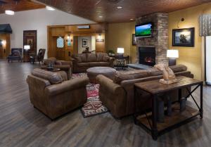 a large living room with couches and a fireplace at Ramkota Hotel - Casper in Casper