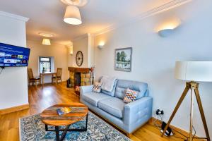 a living room with a blue couch and a table at Union Place in Sligo