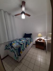 a bedroom with a bed and a ceiling fan at Cabo Frio - Residence in Cabo Frio