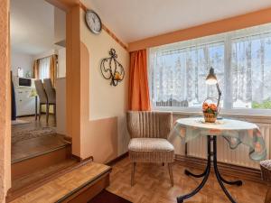 a living room with a table and a chair and a window at Schönes Ferienhaus in Biendorf mit Garten in Körchow