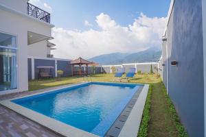 a swimming pool in the backyard of a house at Marseillia Hills in Puncak