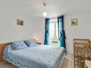 a bedroom with a bed with blue sheets and a window at Holiday home in Cendrieux with garden shed in Cendrieux