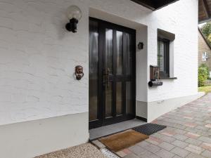 a black door on the side of a house at Cosy holiday home in Olsberg with garden in Olsberg