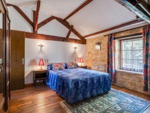 a bedroom with a bed and two lamps on two tables at Cosy holiday home with garden in Villefranche-du-Périgord