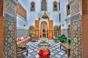a living room with a couch and a table at RIAD CHAHD PALACE in Fès