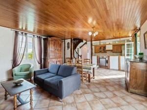 a living room with a couch and a table at Vintage Holiday Home in Loubejac with a Private Pool in Villefranche-du-Périgord