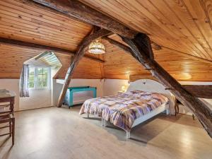 a bedroom with a bed in a wooden ceiling at Vintage Holiday Home in Loubejac with a Private Pool in Villefranche-du-Périgord