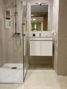 a bathroom with a shower with a sink and a mirror at New Studio Sito 8 Parking Gratis in Salamanca