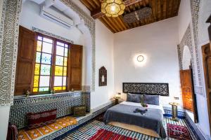 A bed or beds in a room at RIAD CHAHD PALACE